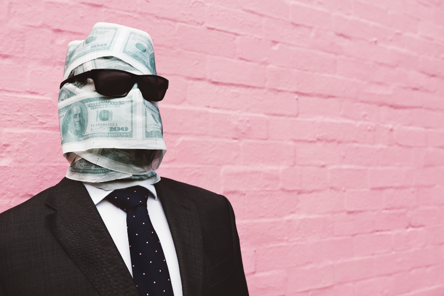 A man posing with money coated face A man posing with money coated face