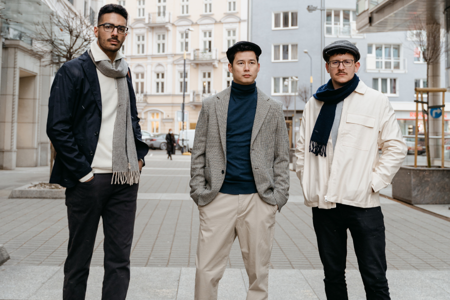 Three men are standing in a stylish outfit Three men are standing in a stylish outfit
