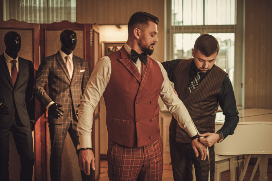 Tailor measuring a man Tailor measuring a man